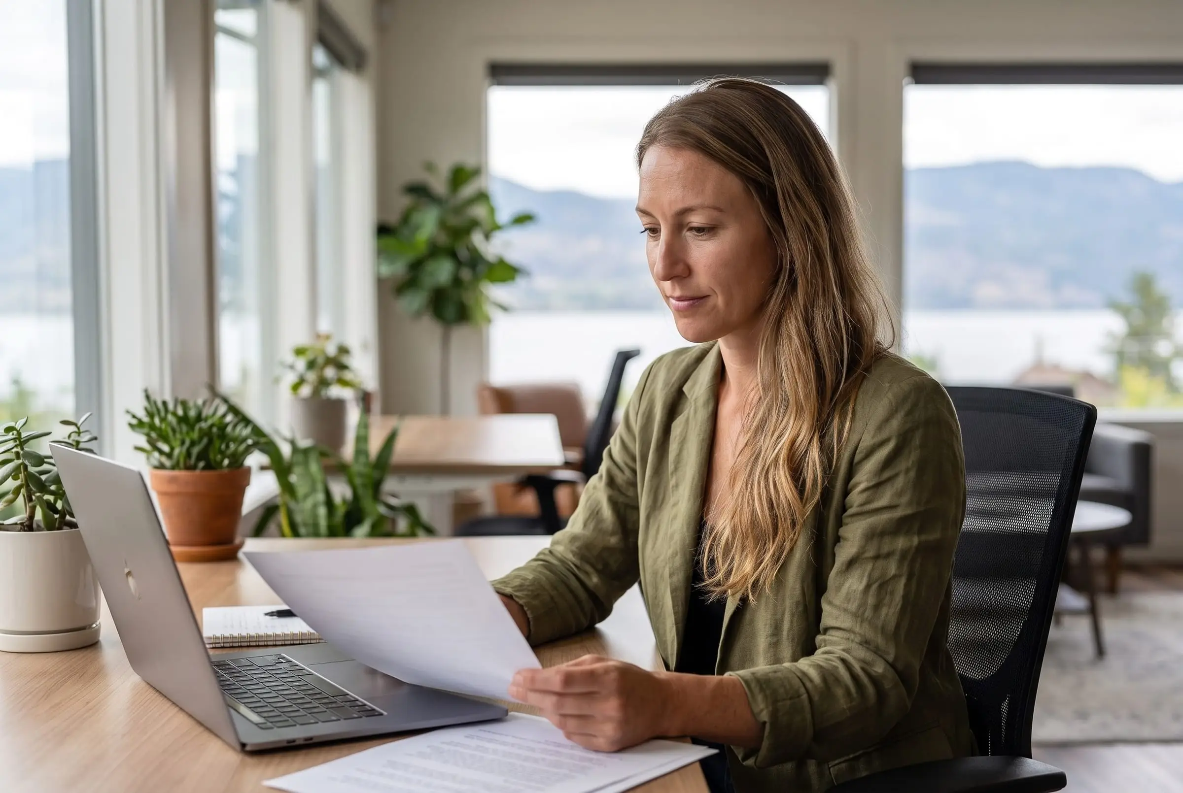Sofia Lindqvist reviewing a file at her desk